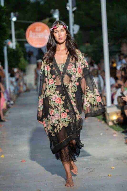 Fashion model showcasing floral kimono on runway at La Galeria Elefante.