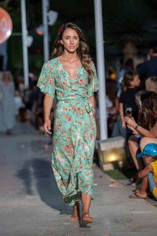 Stylish woman in light green floral dress on runway atLa Galeria Elefante Ibiza - Atzaro fashion show Ibiza