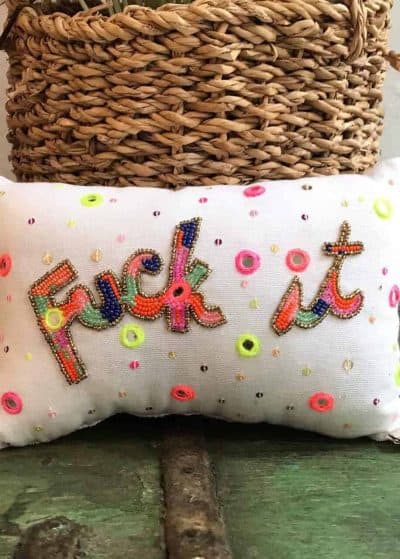 cushion filled with lavender with the word fuck-it embroidered on it in multicoloured beads