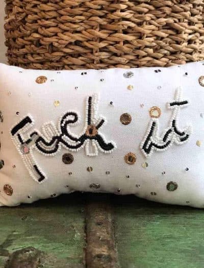 cushion filled with lavender with the word fuck-it embroidered on it in black