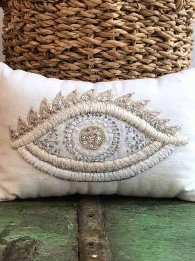 cushion filled with lavender with a cream coloured eye embroidered on it