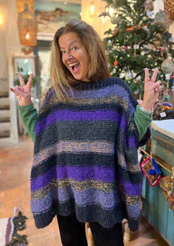 Warm, colorful knit sweater with purple, black, and gold stripes for stylish comfort.