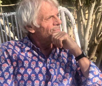 This image features a thoughtful senior man sitting outdoors at La Galeria Elefante, capturing a peaceful, artistic atmosphere perfect for visitors seeking cultural and nature experiences.