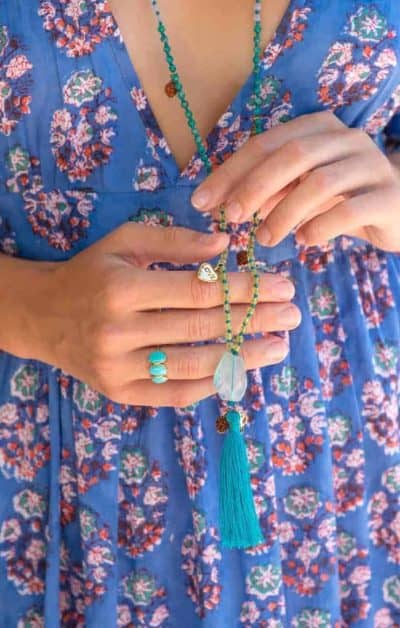 long beaded necklace with a turquoise tassel