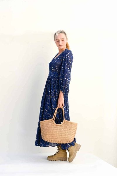 navy long sleeved dress with gold stars and a leather basket