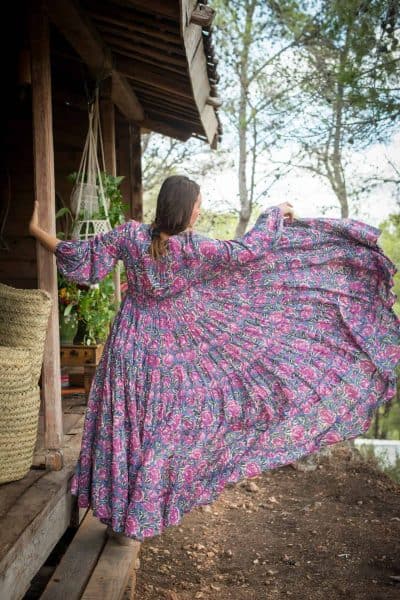 back view twirling in a grey and pink maxi dress