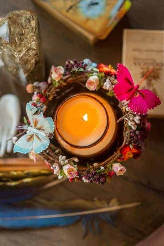 Candle in a wicker basket with butterflies and flowers