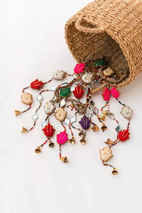 Decorative cloth garland with Hamsa hands, kite mirrors and bells