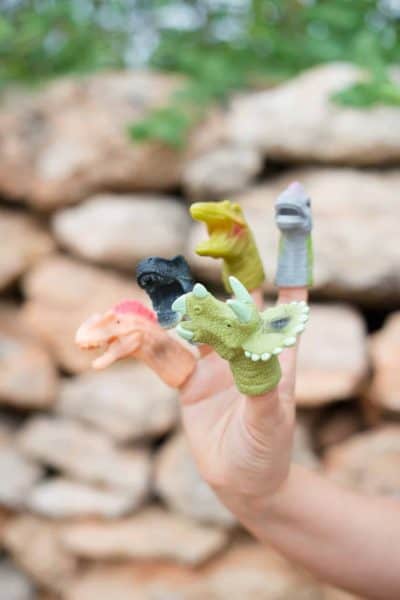 Dinosaur finger puppets on five fingers