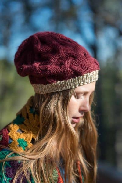close up view of a burgundy knitted hat