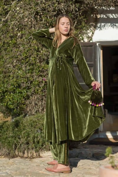 long velvet wrap around coat in green worn with matching trousers