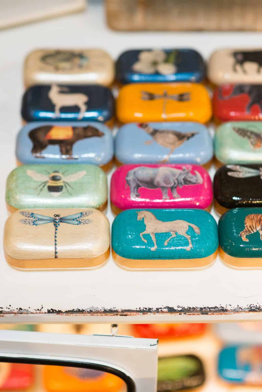 Colorful elephant and animal-themed soaps, decorative tins showcasing wildlife art, perfect for boutique gift shop decoration at La Galeria Elefante, Ibiza