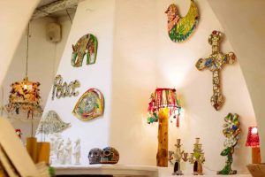 Colorful mosaic elephant wall art and decorative cross in La Galeria Elefante, showcasing vibrant Mexican folk art and handcrafted adornments.