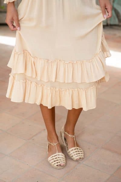ruffle detail on a cream dress worn with sandals