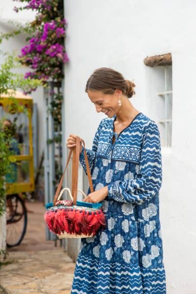 red feather basket with blue and white dress