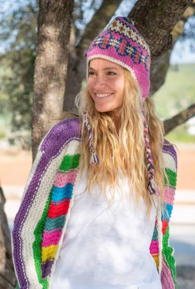 pink woolly hat worn with striped cardigan