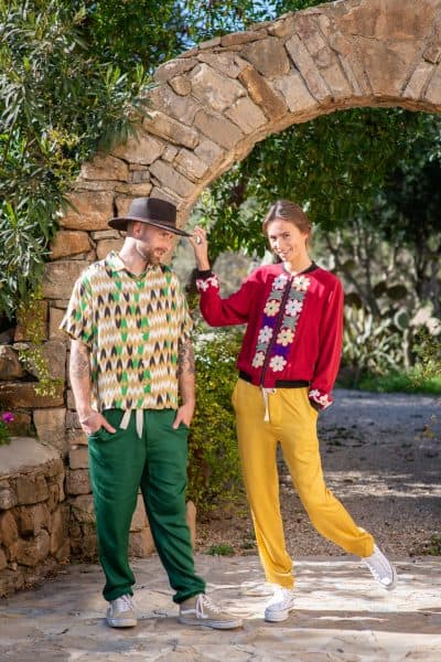 Models wearing matching modal trousers in green and yellow in a garden