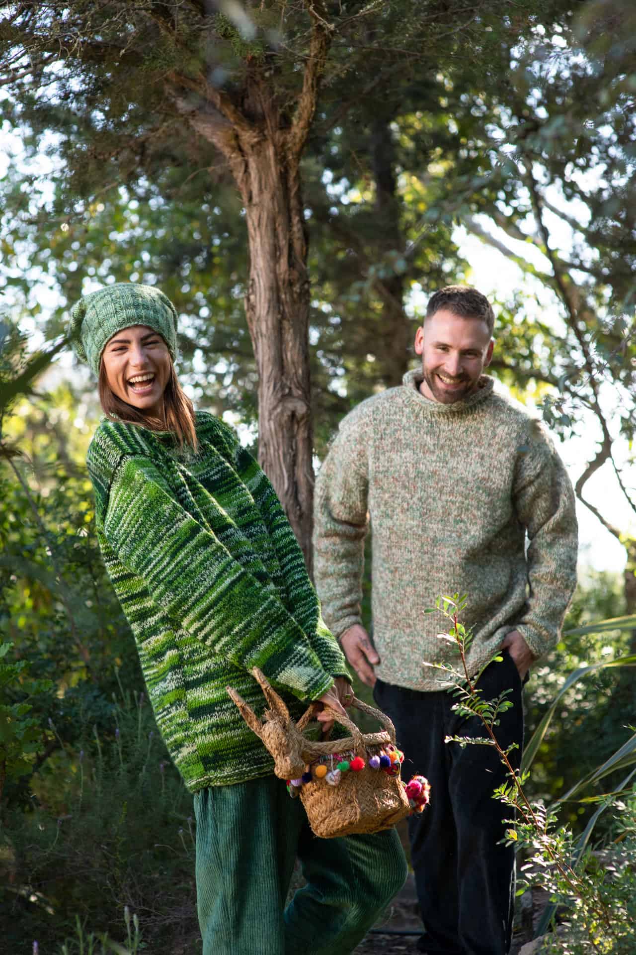 Models wear matching corduroy trousers and matching woolly jumpers in a garden