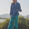 teal silk trousers with blue jacket