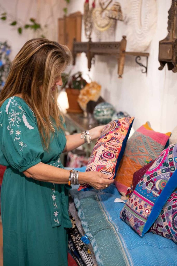 Vibrant embroidered pillows and textiles displayed at La Galeria Elefante, showcasing colorful, handmade crafts perfect for home decor enthusiasts and lovers of unique, artistic textiles. La Galeria Elefante in Monsoon