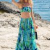 A woman in a blue and green floral skirt and matching blue and green tube top