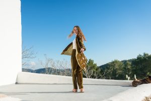La Galeria Elefante Ibiza Model in bohemian outfit with velvet jacket and butterfly design in Ibiza setting.