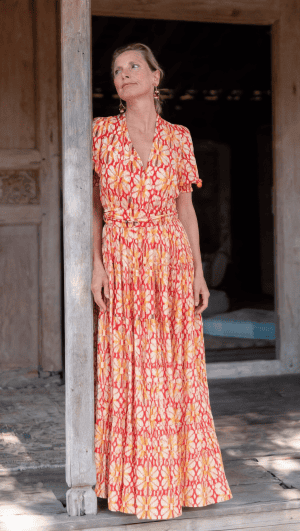 La Galeria Elefante Ibiza Woman in colorful bohemian cotton dress with floral pattern in Ibiza setting.