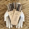 Aromatic smudge sticks gift box with natural incense, including lavender, rose, sandalwood, and green tea, presented on a decorative white skull, perfect for spiritual cleansing and gift-giving.