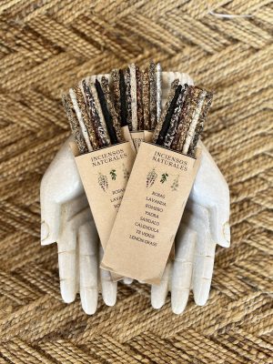 Aromatic smudge sticks gift box with natural incense, including lavender, rose, sandalwood, and green tea, presented on a decorative white skull, perfect for spiritual cleansing and gift-giving.