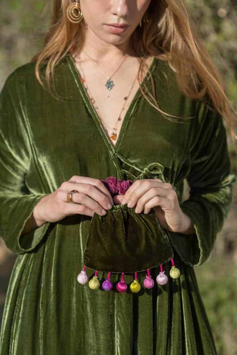 Vintage green velvet dress with jewelry and colorful accessory from La Galeria Elefante.