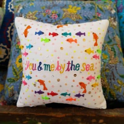 you and me by the sea embroidered on a cushion with fish