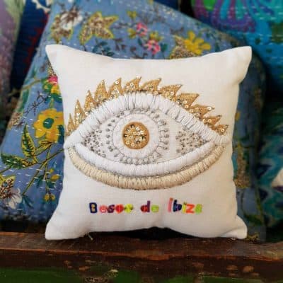 embroidered cushion with an eye and besoms de ibiza on it